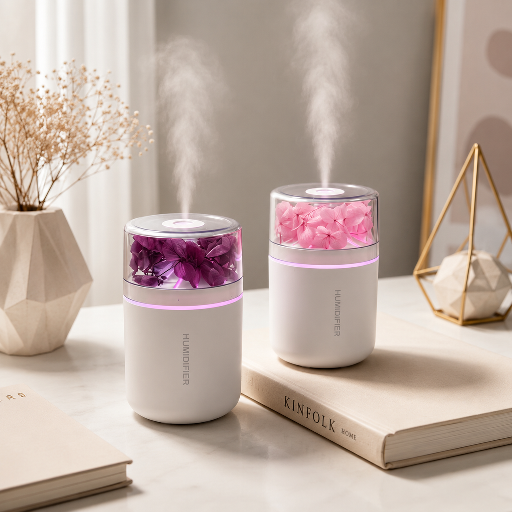 USB flower humidifier with floral mist beside laptop